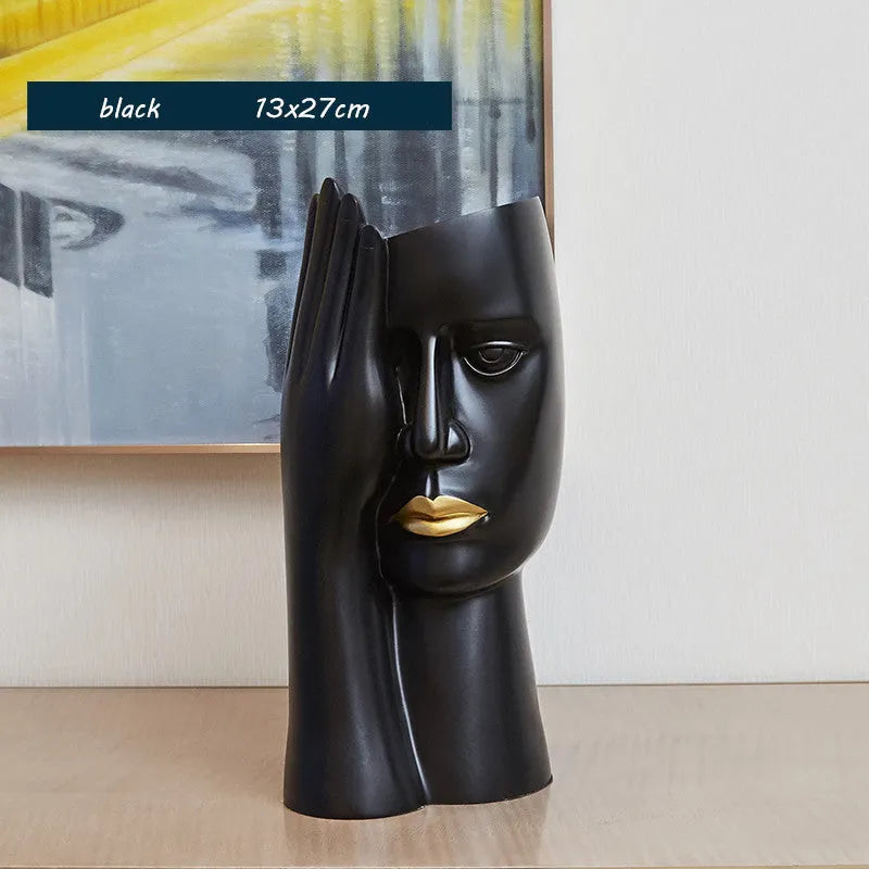 Modern black and white resin vase with sculpted body shape on living room table