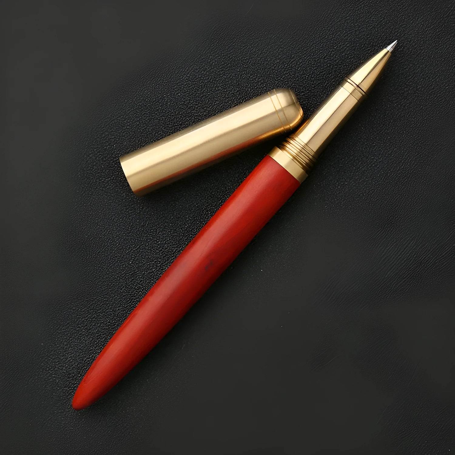 Brass and sandalwood solid wood signature pen with wooden barrel and brass fittings on a desk