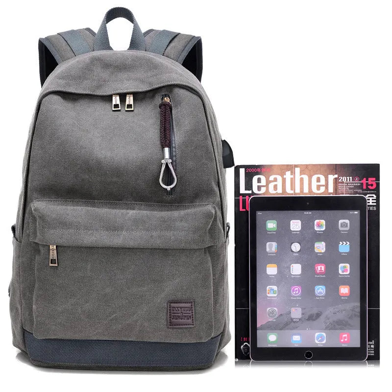 Canvas backpack with USB charging port showing multiple compartments including laptop pocket