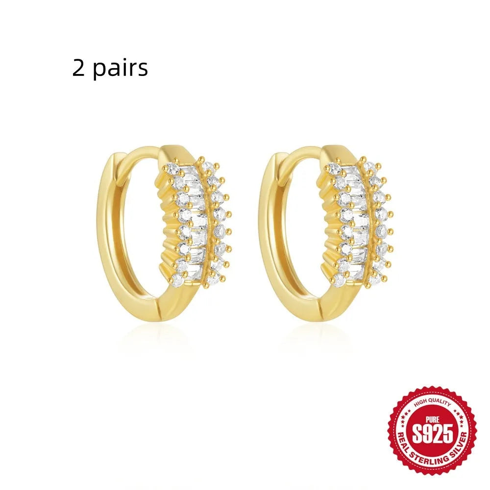 Small round geometric sterling silver stud earrings in gold and silver electroplated finishes.