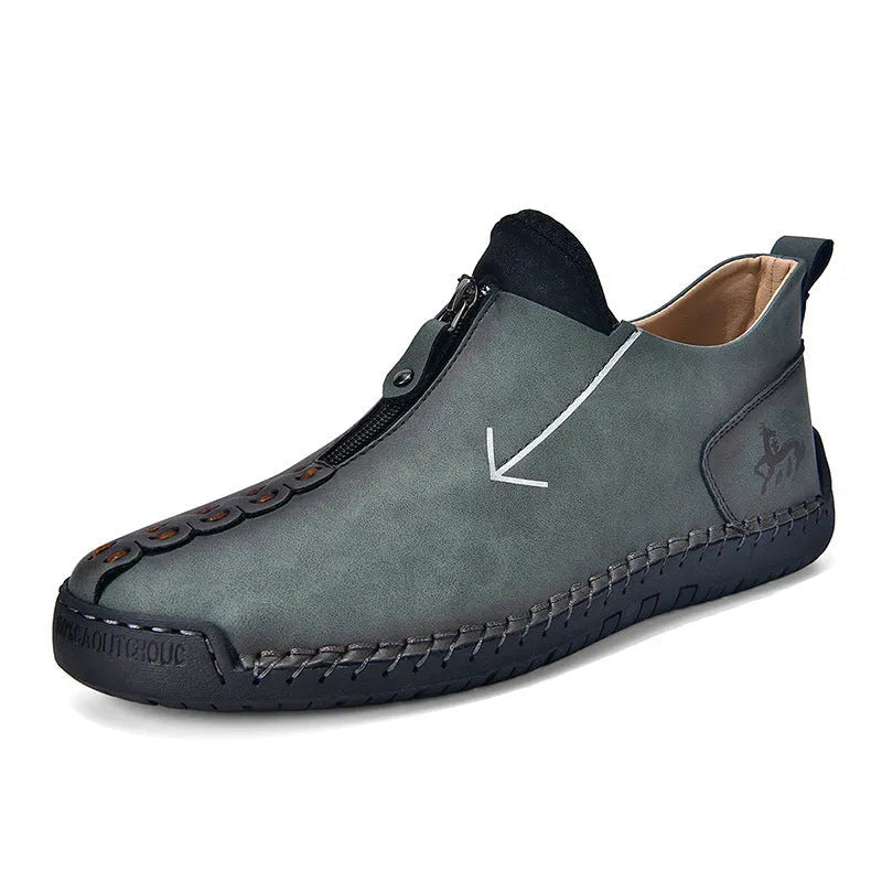 Men's black leather zip-up boots with round toe and hand-stitched rubber sole on a white background.