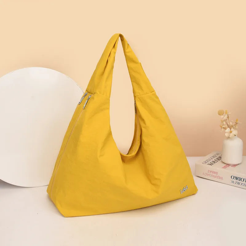 Women's soft nylon underarm bag in a heart shape, shown in black, blue, khaki, and yellow colour options.