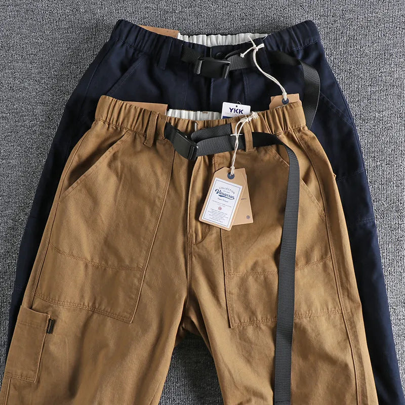 Men's khaki cotton work trousers showing N I buckle belt and three-dimensional cutting detail