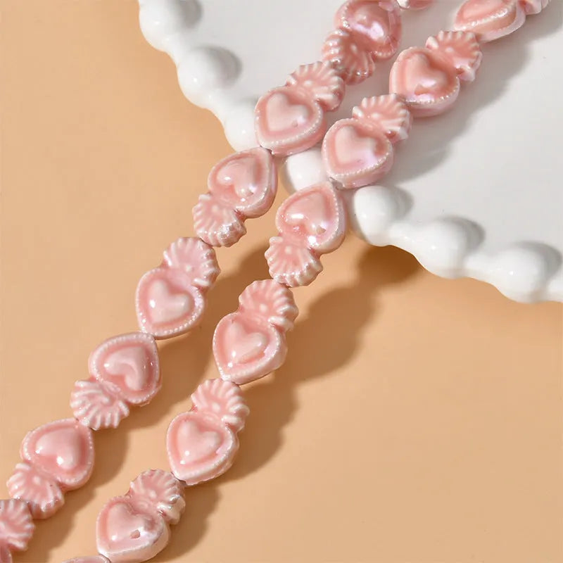 Ceramic heart torch beads in various colours for jewellery making, approximately 10mm by 15mm with straight hole