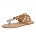 Women's black slip-on sandals with rhinestone detail, hollow-out design, and flat rubber sole.