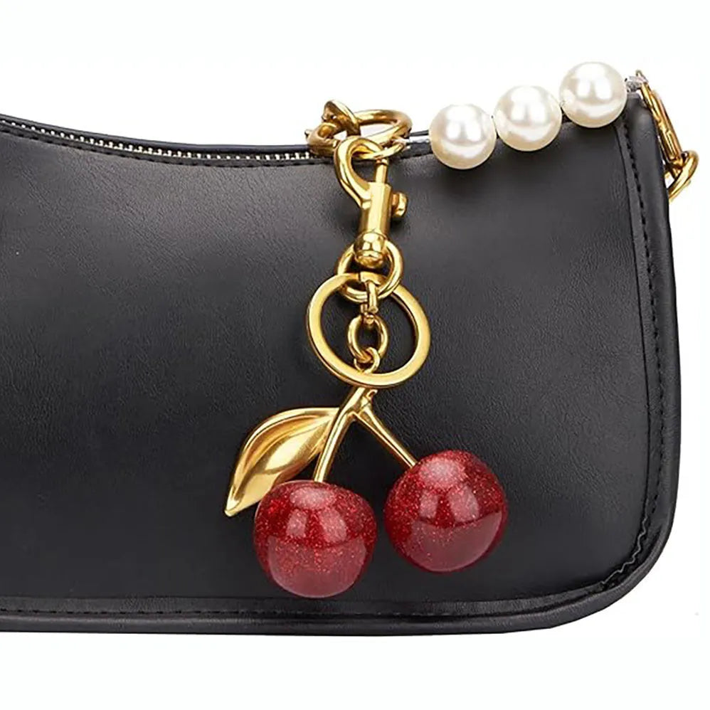 Red or pink zinc alloy cherry pendant keychain for car keys and bags.
