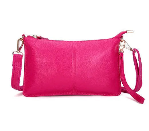 Structured cowhide lady slant bag in apricot colour with hand strap and shoulder strap, showing slim profile.