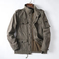 Man wearing a light brown loose-fit cotton zip-up jacket, retro casual style.