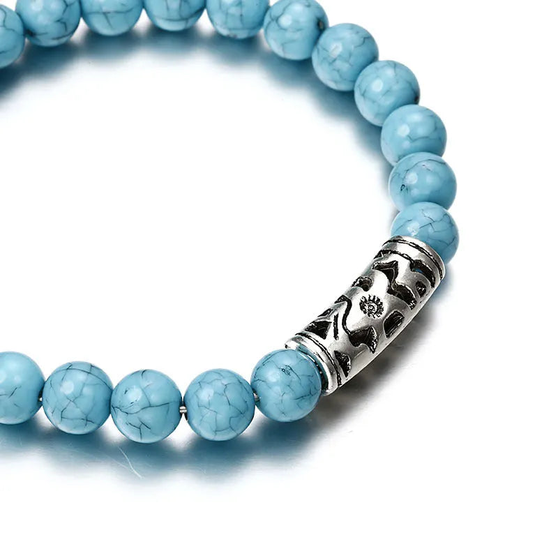 Classic acrylic blue beaded bracelet on stretch cord on a light background