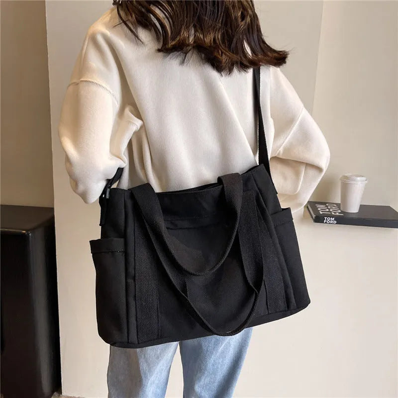 Polyester shoulder bag in solid colour with sandwich pocket and phone compartment