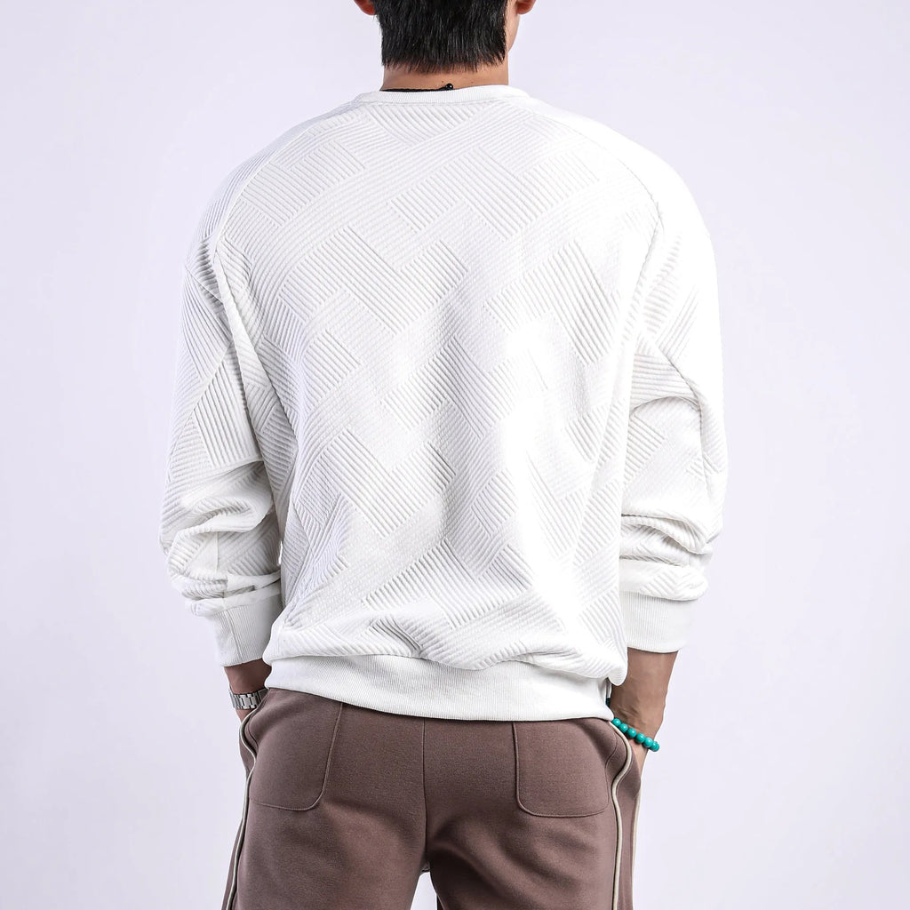 Man wearing a loose-fit army green twill jacquard long-sleeved pullover sweater.