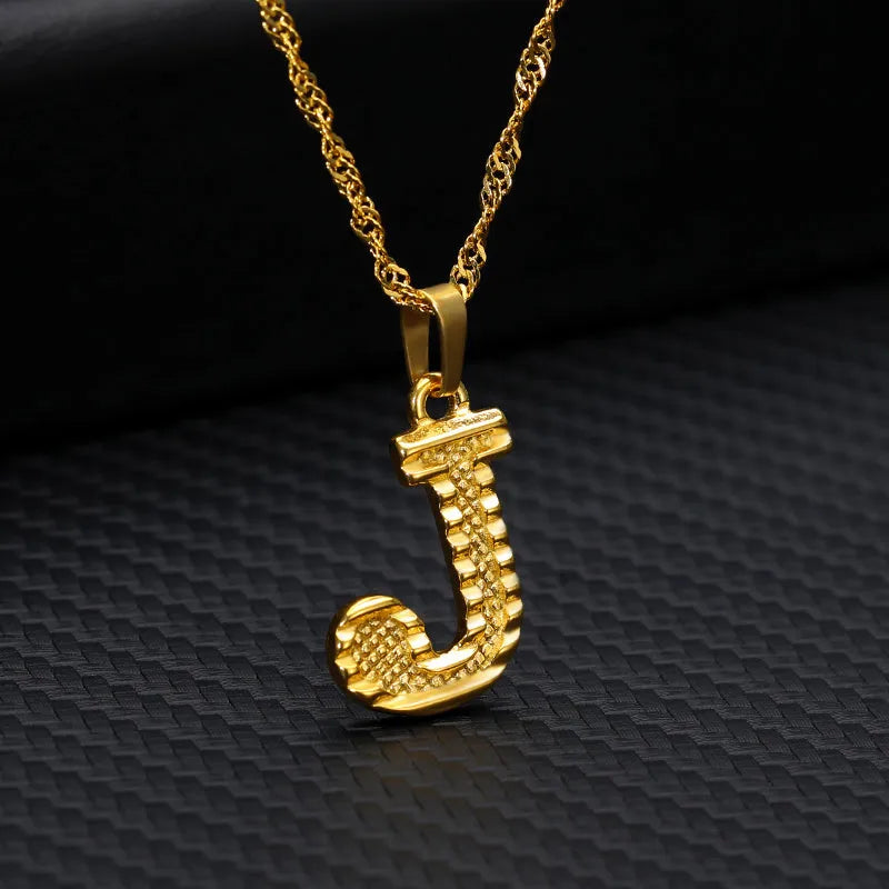 Gold-plated alloy initial pendant necklace with 42cm chain on white background