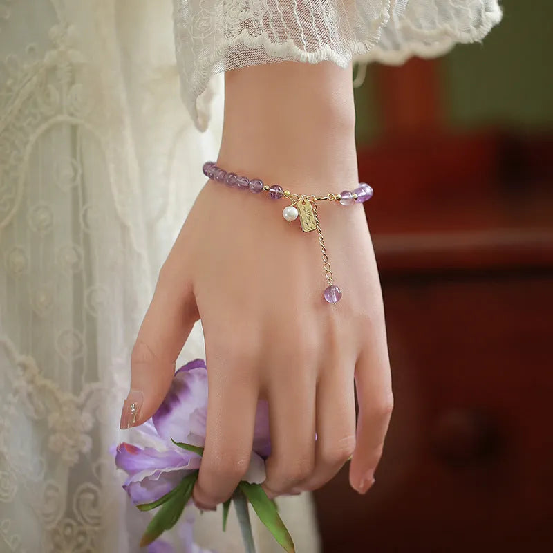 Women's natural lavender amethyst crystal bracelet showing dark and light colour options
