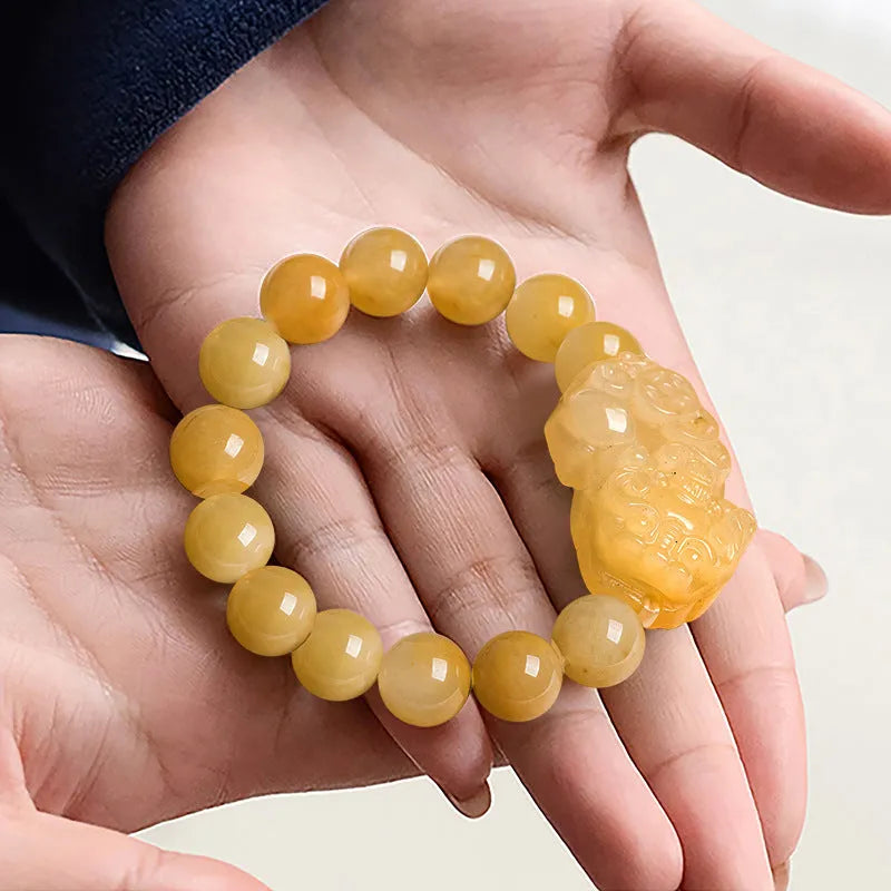 Carved Jinsi Jade money bracelet with Chinese characters on leather cord in gold thread colour