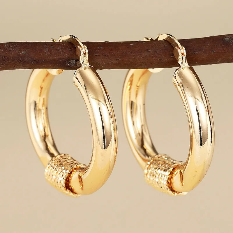 Geometric copper earrings for women in golden colour with ring and line design elements