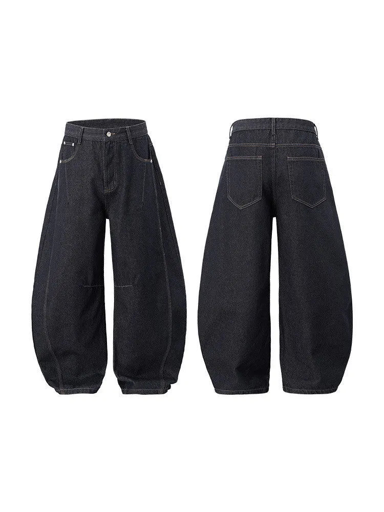 Men's original cow colour wide leg denim trousers laid flat showing mid-waist and relaxed leg cut