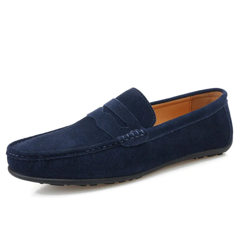 Men's solid colour suede loafers with round toe and rubber sole on a neutral background.