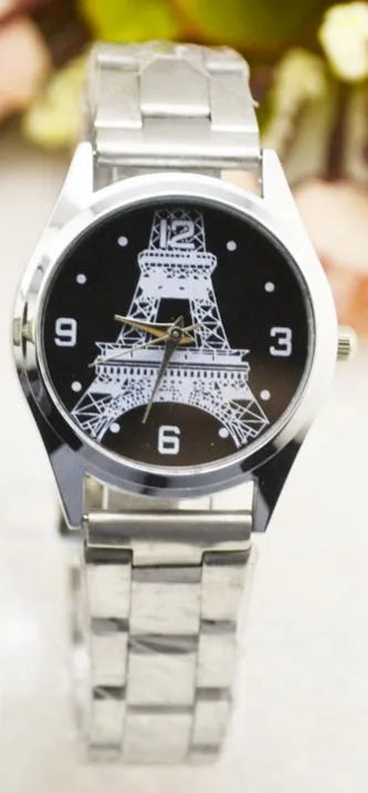 Round stainless steel watch with engraved Eiffel Tower design and Roman numeral markers