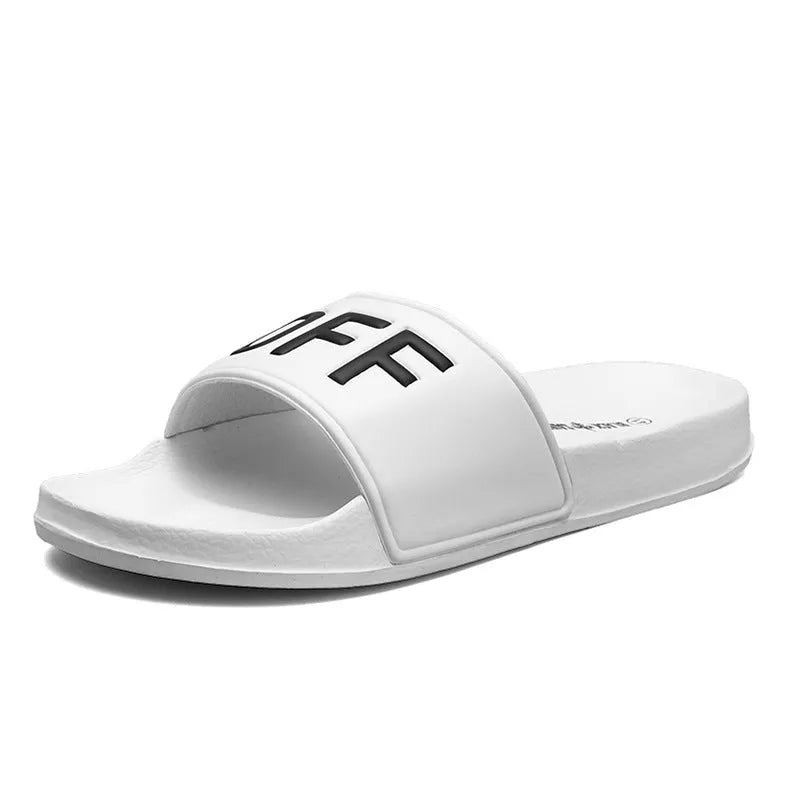 Men's black open toe slippers with a rubber sole on a wooden floor.