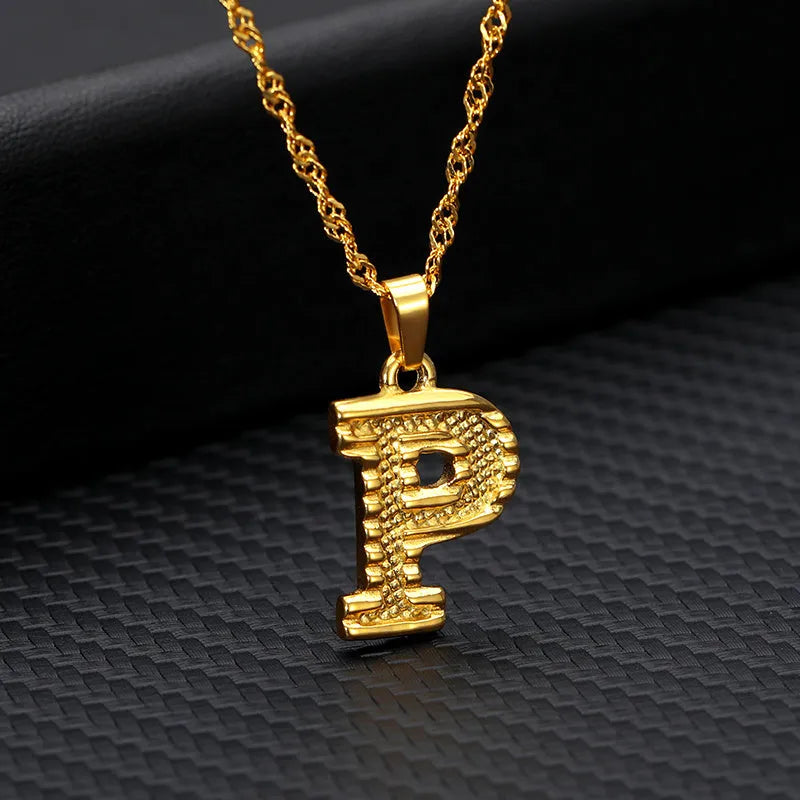 Gold-plated alloy initial pendant necklace with 42cm chain on white background