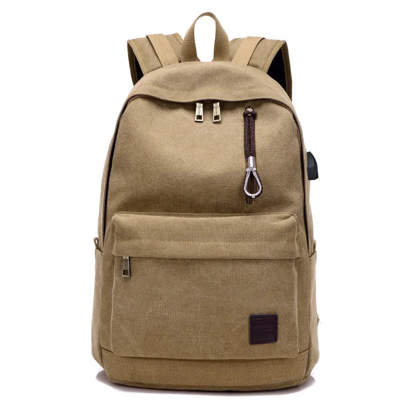 Canvas backpack with USB charging port showing multiple compartments including laptop pocket