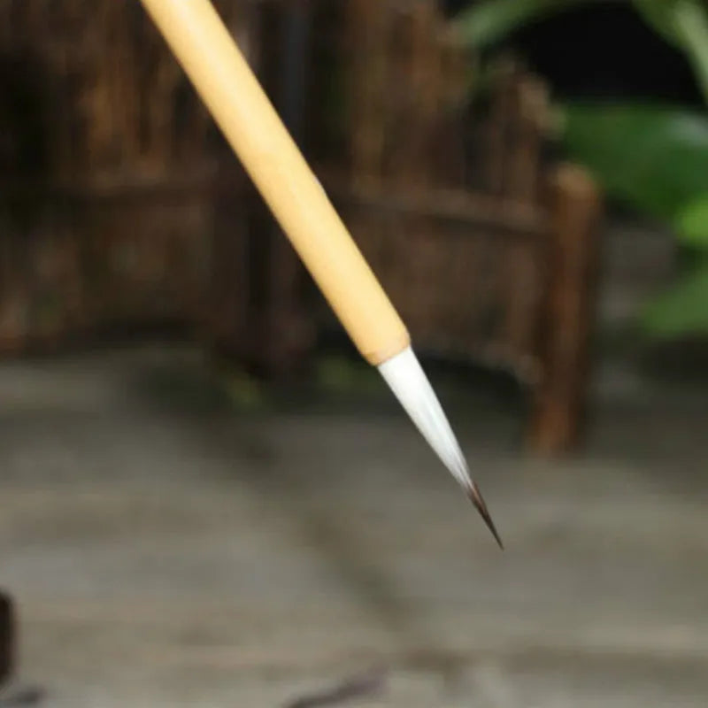 Set of four lower case writing brushes with thin gold body and mixed hair tip in pine branch colour for calligraphy