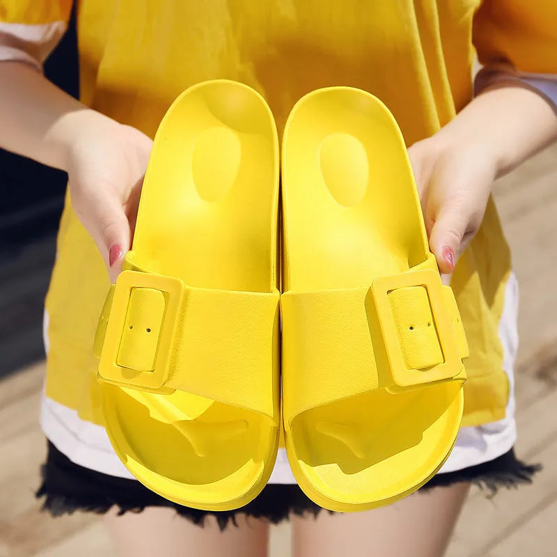 Women's grey blue buckle fastening flip-flop sandals with a soft EVA sole on a white background.