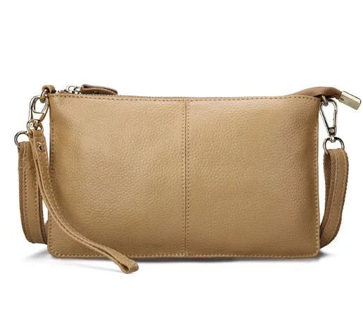 Structured cowhide lady slant bag in apricot colour with hand strap and shoulder strap, showing slim profile.