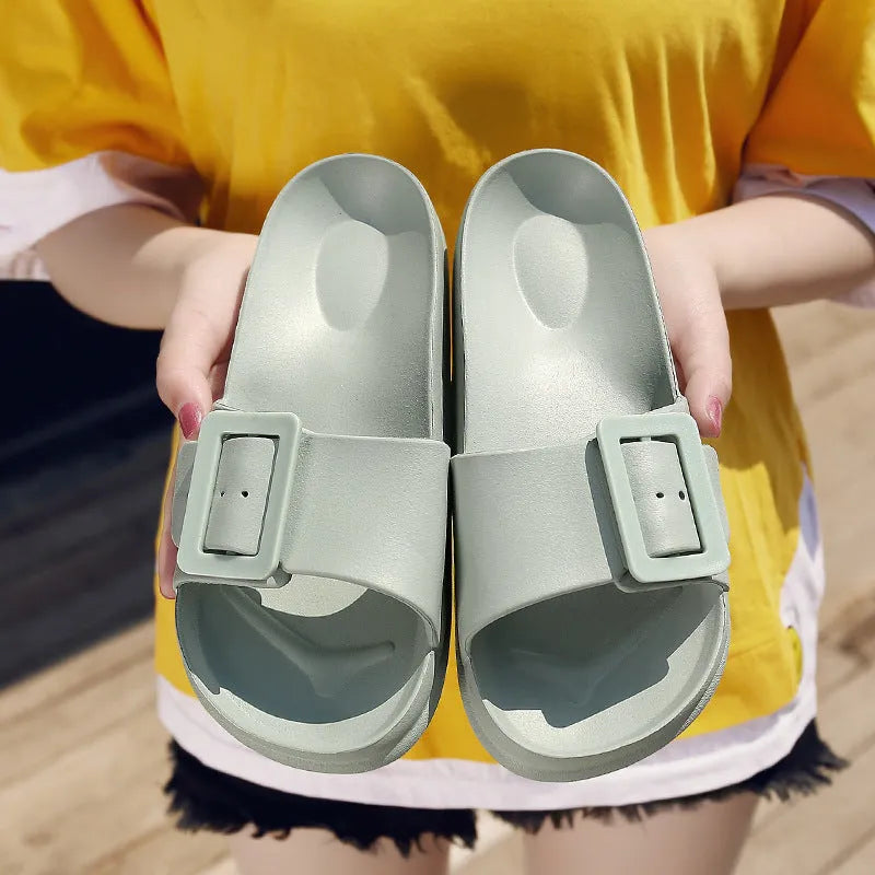 Women's grey blue buckle fastening flip-flop sandals with a soft EVA sole on a white background.