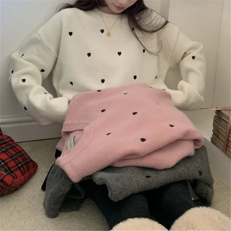Women's loose-fit acrylic pullover sweater with embroidered heart detail on the front.