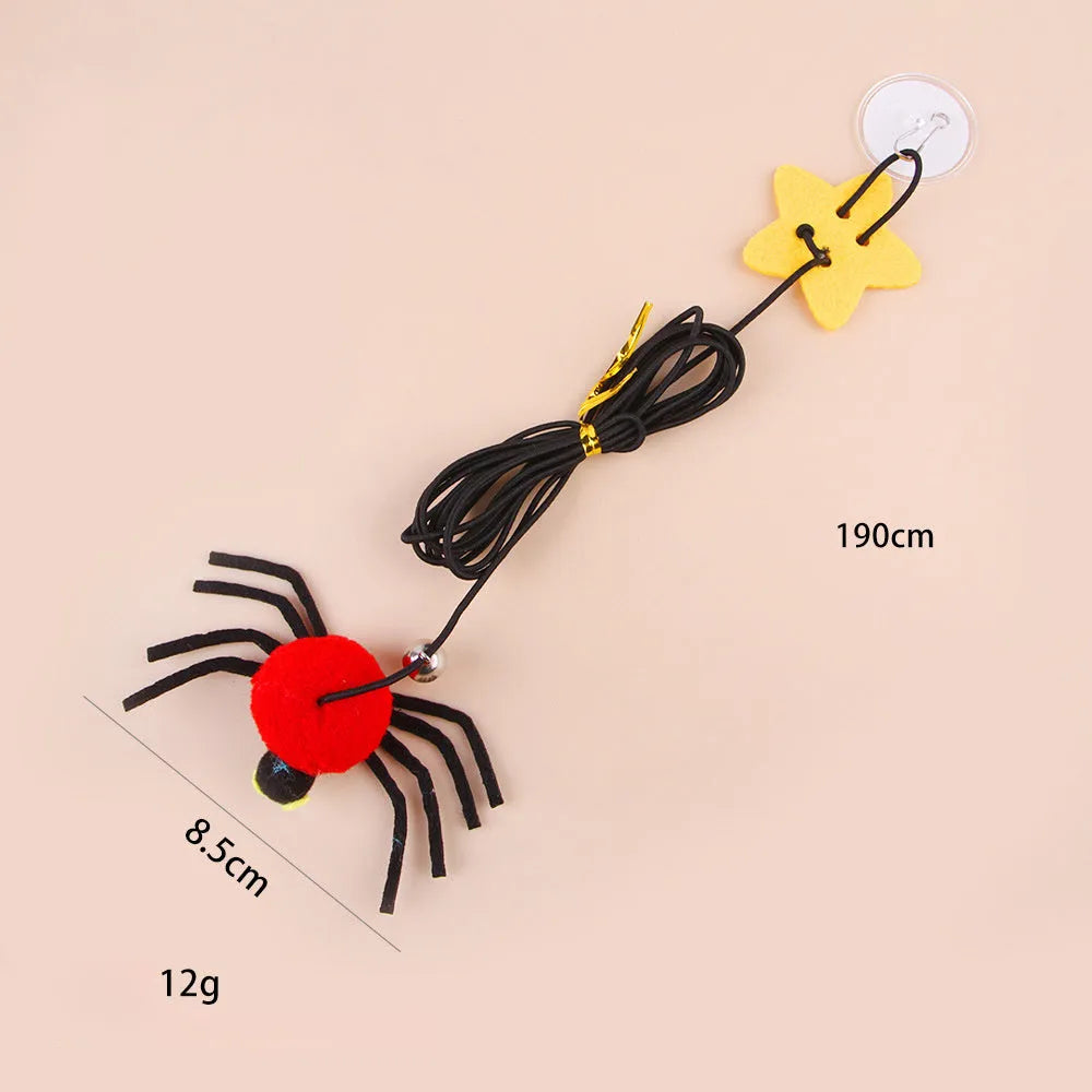 Hanging door cat toy with elastic rope, feather, bell, and spider attachment in red colour