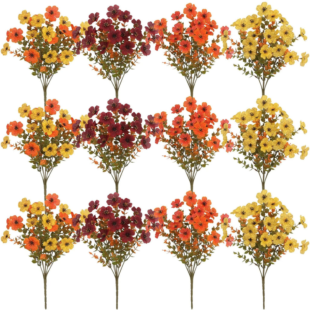 Artificial flower bouquet in autumn red, yellow, orange and orange-yellow colours for home and wedding decoration