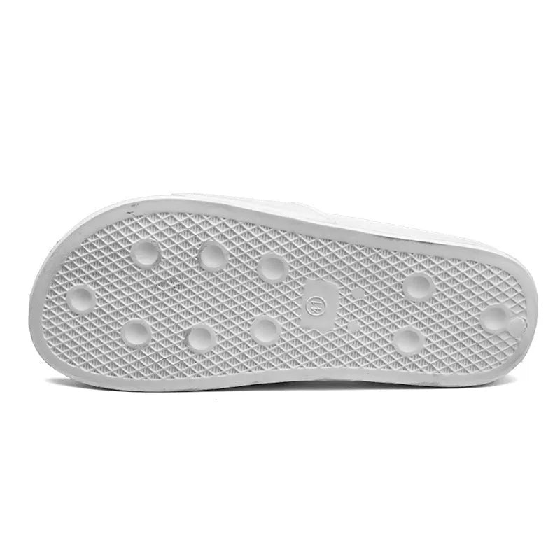 Men's black open toe slippers with a rubber sole on a wooden floor.