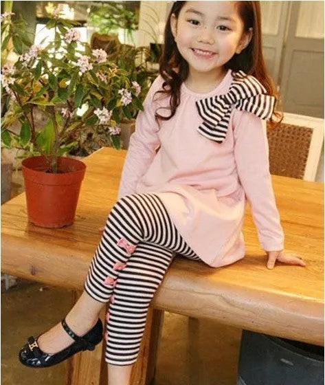 Pink cotton girls two-piece outfit with short-sleeve T-shirt and matching shorts on hanger.