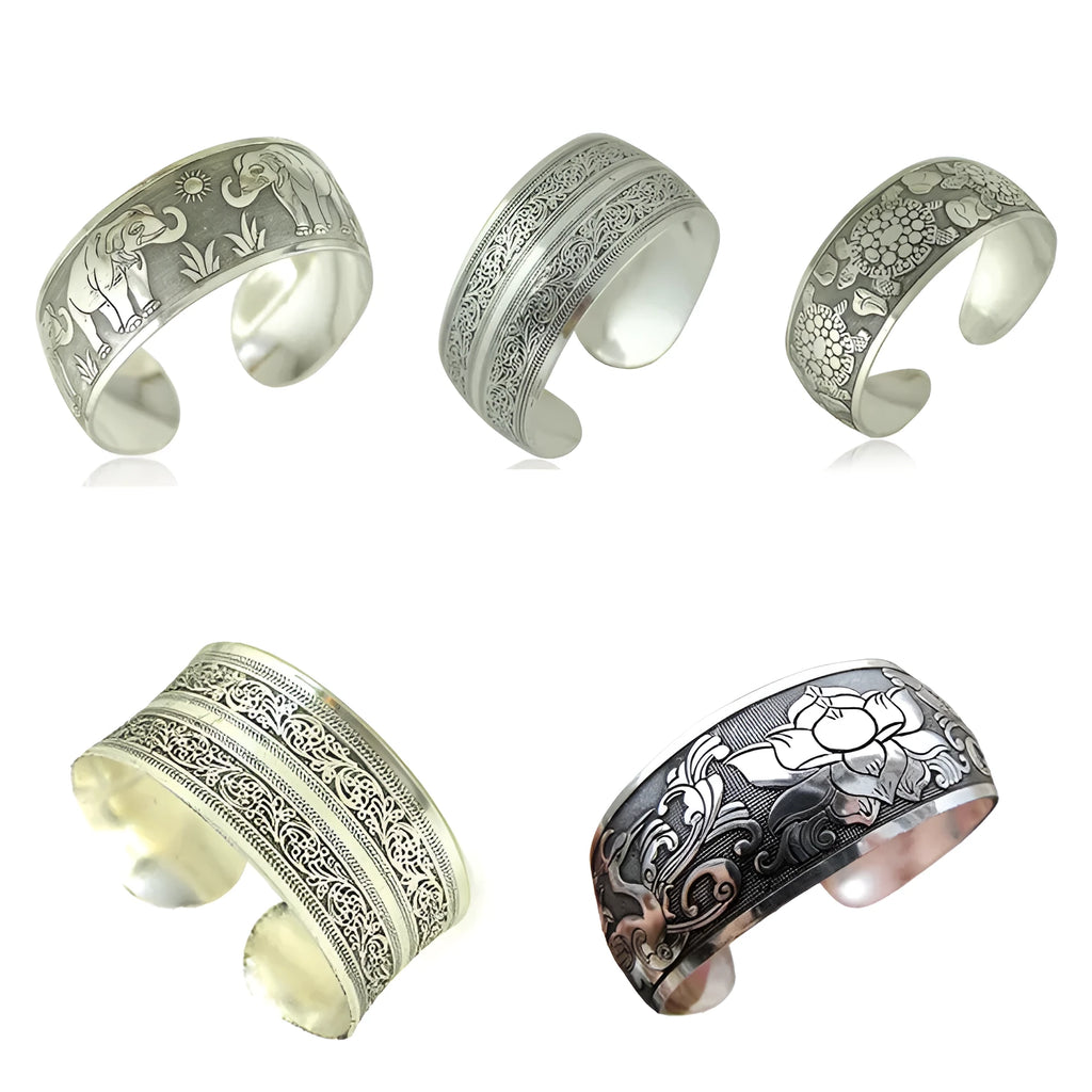 Ethnic style open carved Miao silver alloy bracelet in Roman shape on wrist.