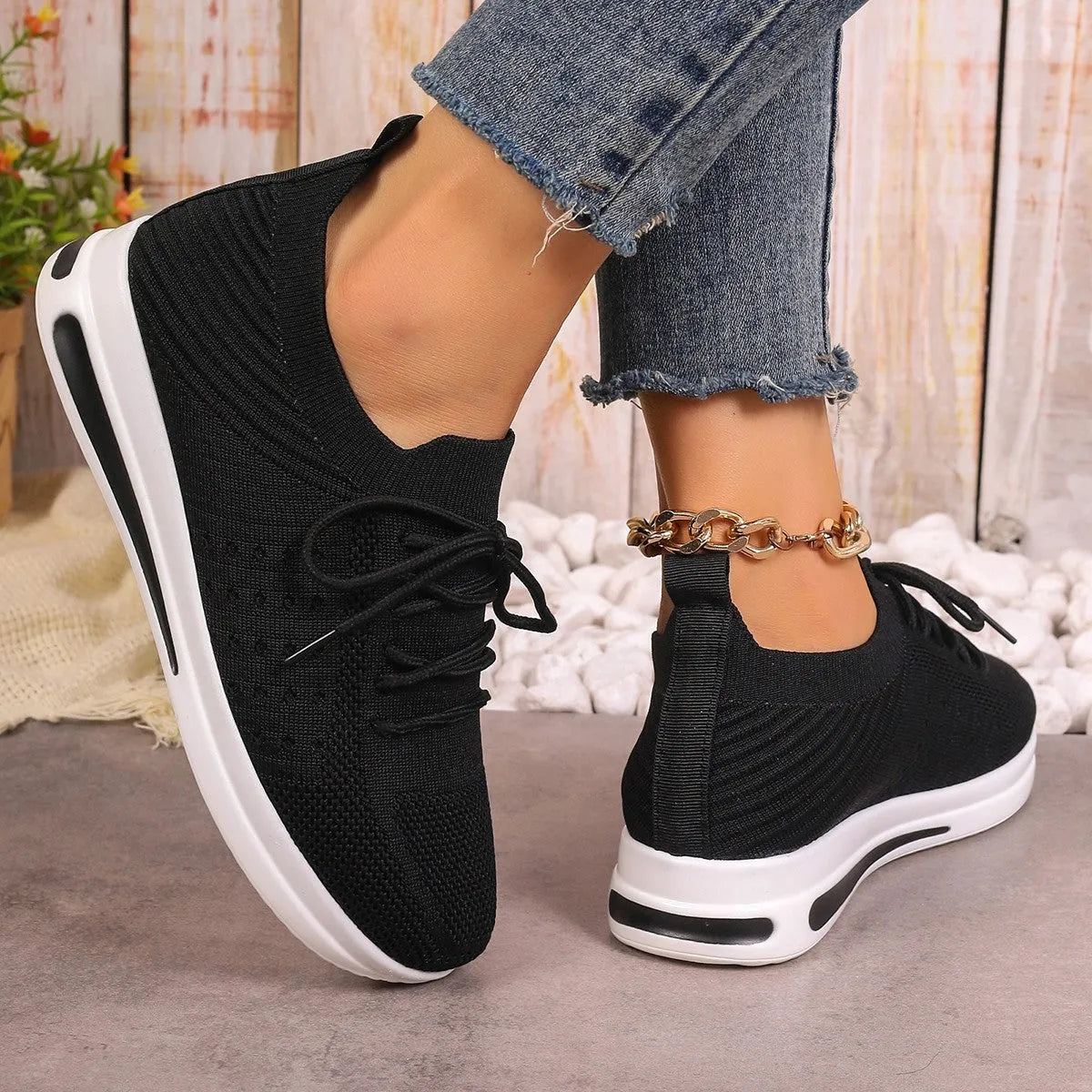 Women's red fly-knit casual sneakers with round toe and lace-up front.