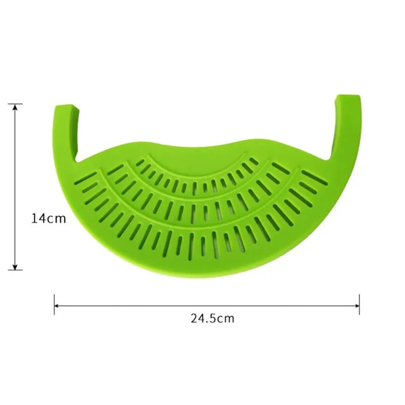 Black silicone food oil drainer snapped onto a pot rim, with liquid being poured off