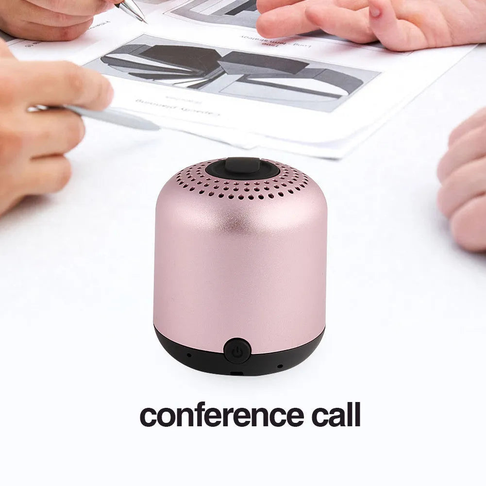 Hieha XQ11 cylinder-shaped mini portable Bluetooth speaker in metallic colour on a table.