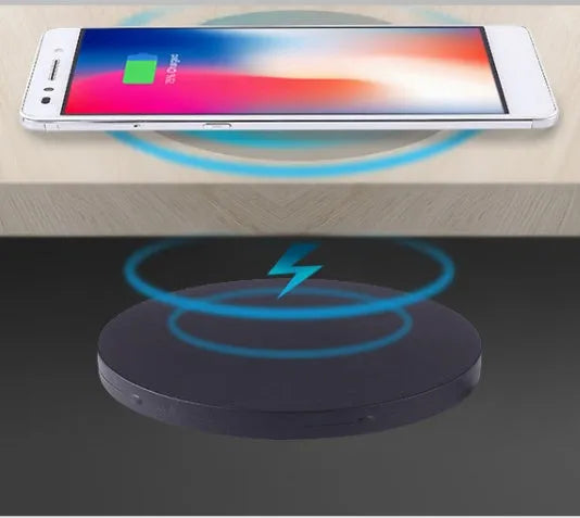 Round 60mm hidden wireless phone charger for installation in furniture.
