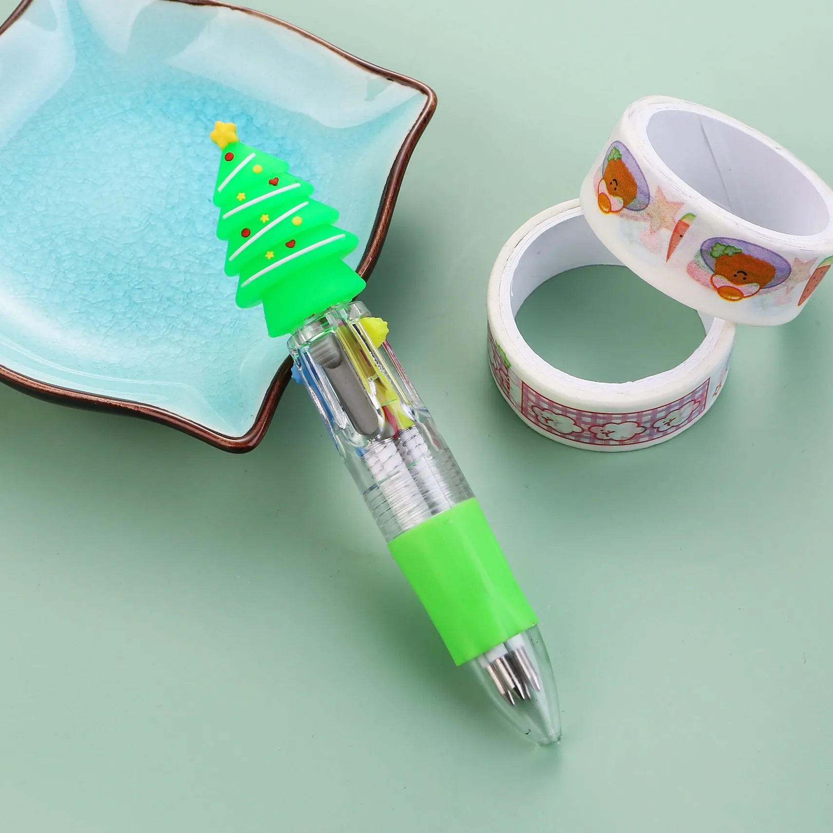 Compact 11cm Christmas-themed press-action ballpoint pen with festive designs.