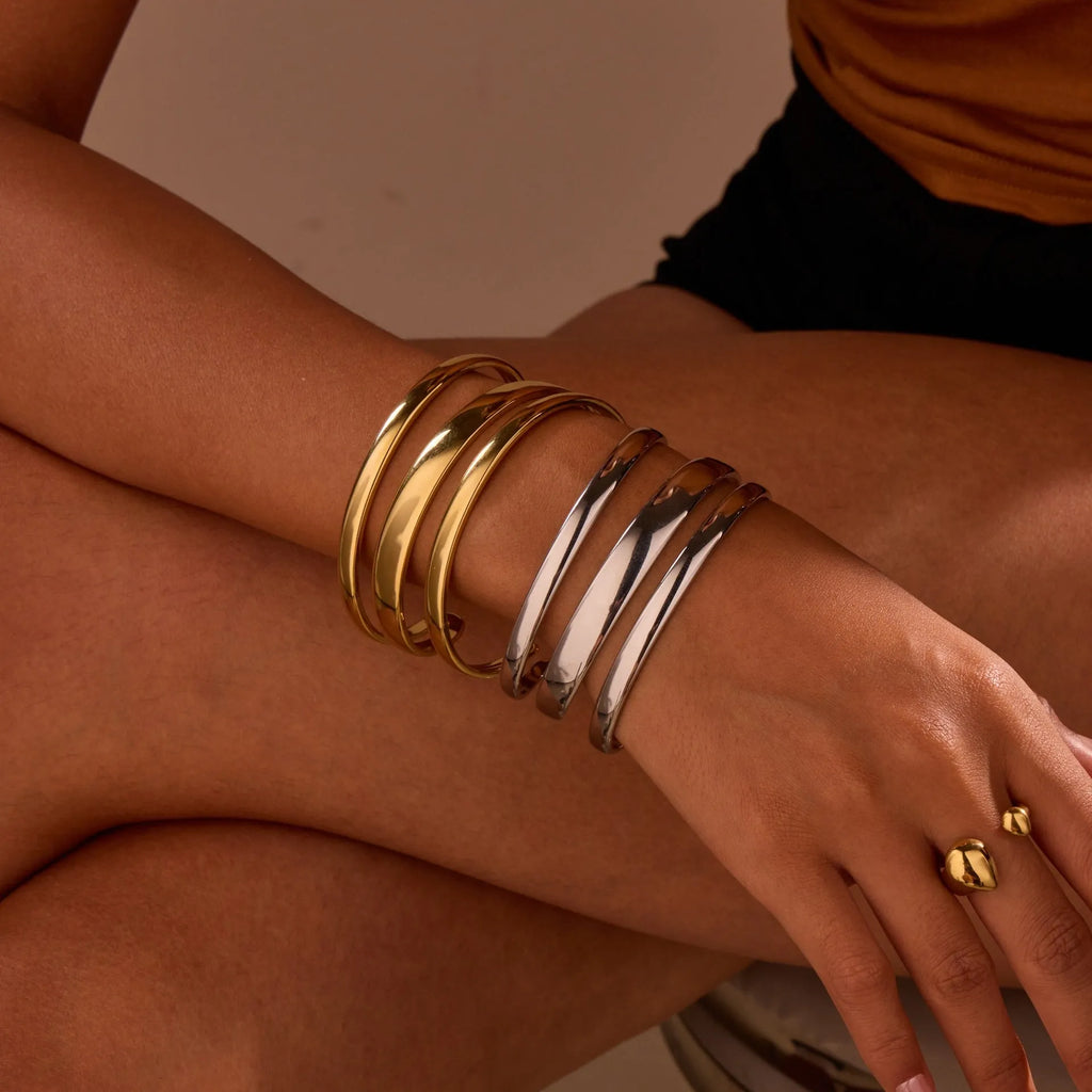 A geometric stainless steel bracelet with a simple opening clasp, shown in a gold electroplated finish.