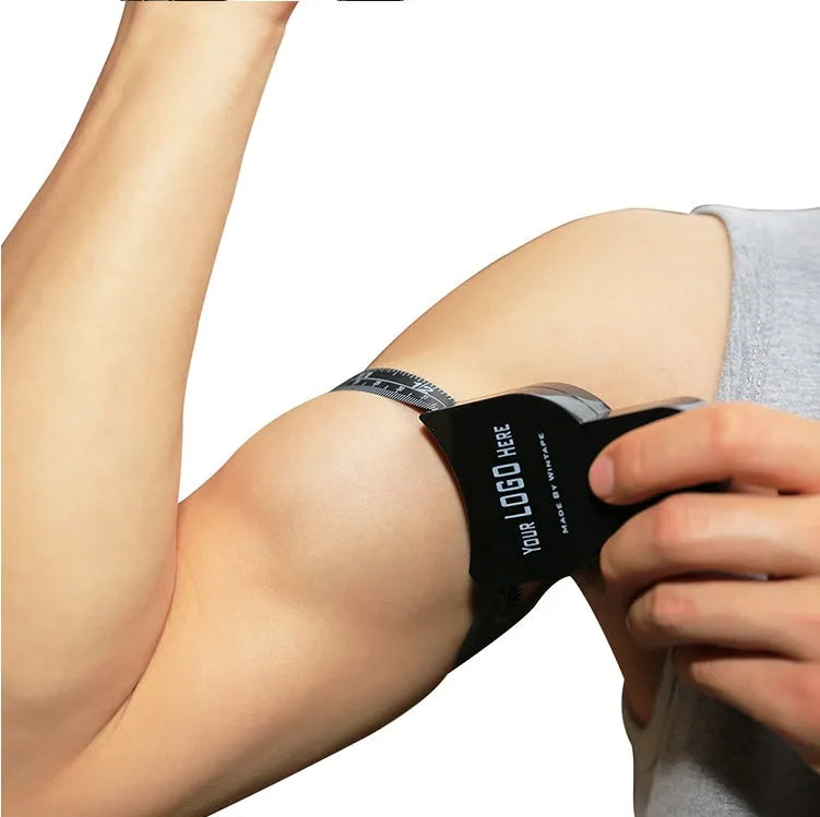 Black ABS body fat caliper with measurement scale and cable for skinfold thickness tracking