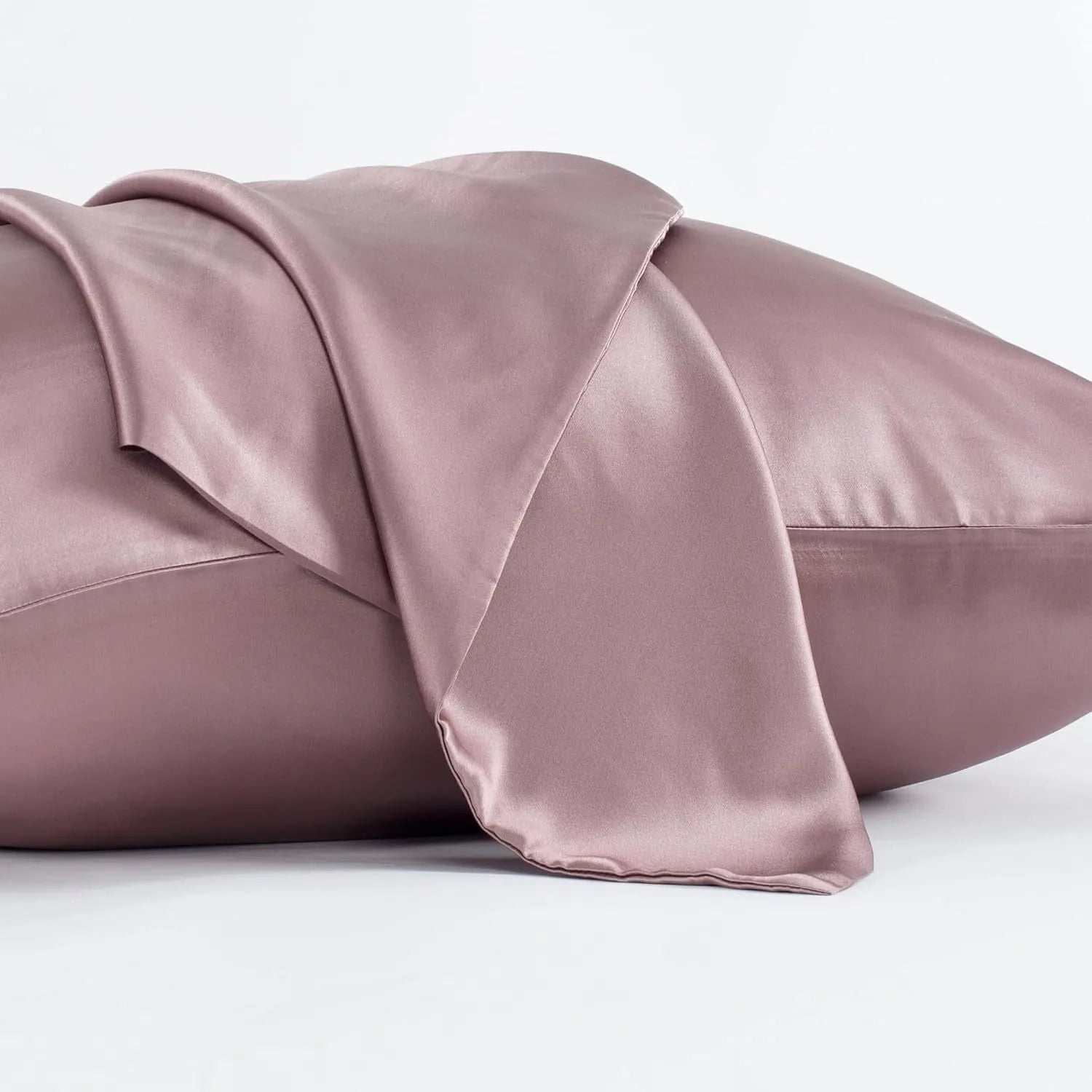 Solid colour mulberry silk envelope pillowcase in dark grey on a bed.