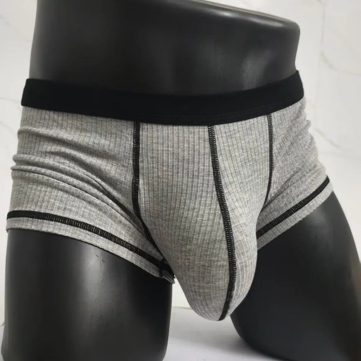 Solid colour men's boxers in breathable thin fabric offering hip lifting and body shaping support.