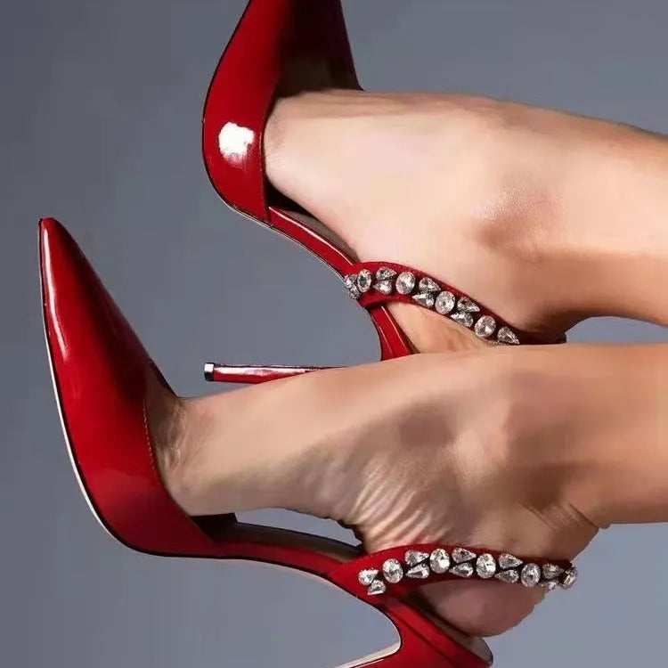 Rhinestone embellished pointed toe high heel sandals in glossy patent leather.