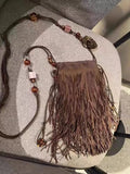 Maroon drawstring beaded tassel crossbody bag with soft plush exterior and single shoulder strap