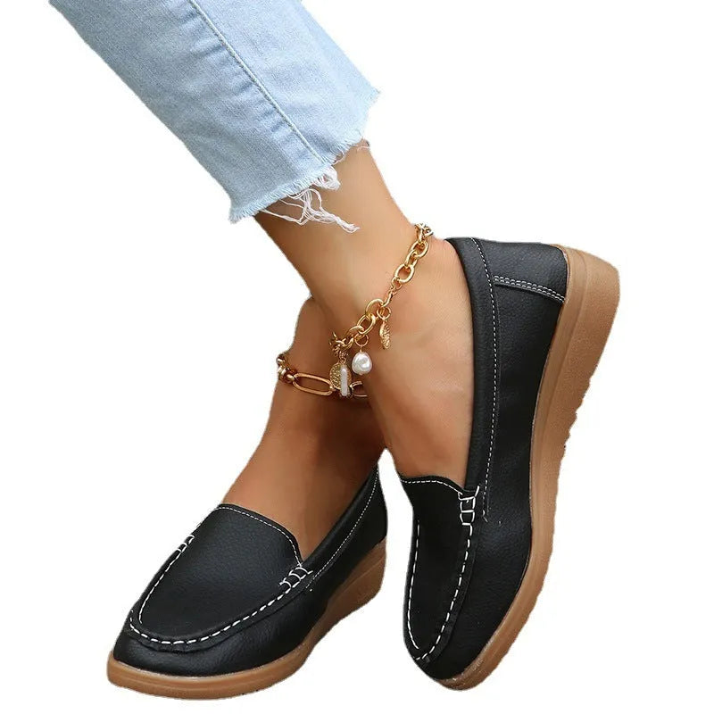 Women's black PU leather slip-on loafers with round toe and flat rubber sole