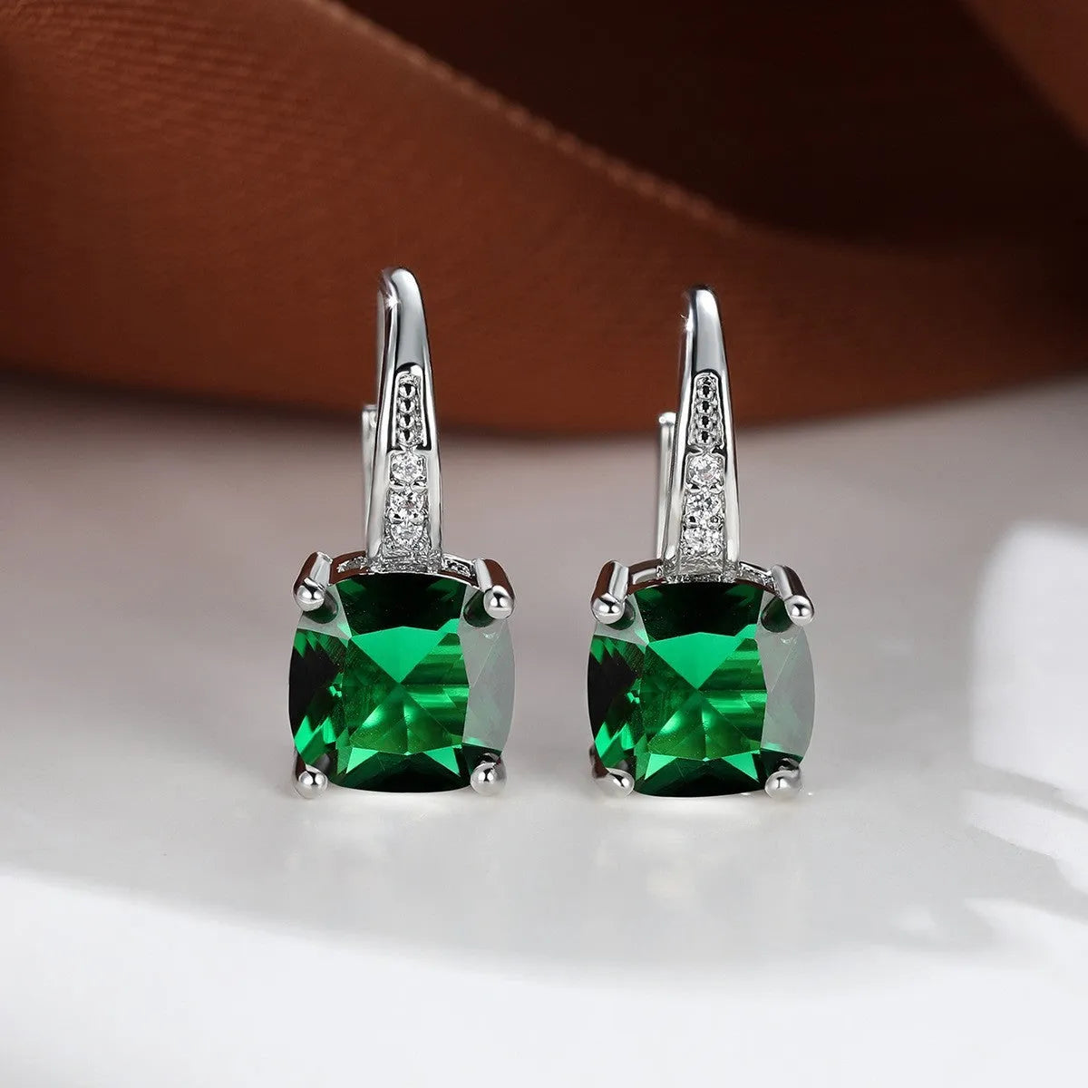 Square geometric ear hook studs with a round zircon stone, shown in a gold electroplated finish.