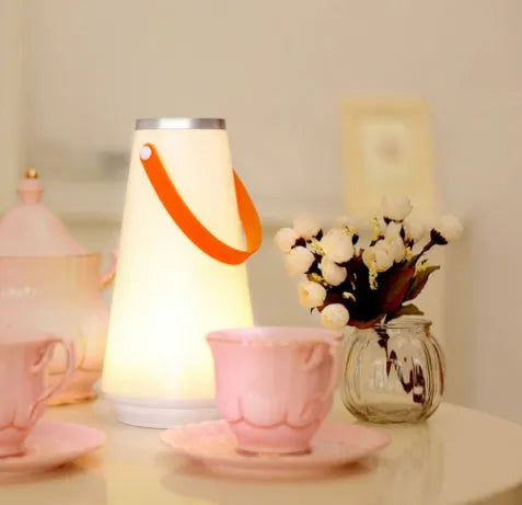 White rechargeable LED bedside lantern with USB cable, showing compact columnar design
