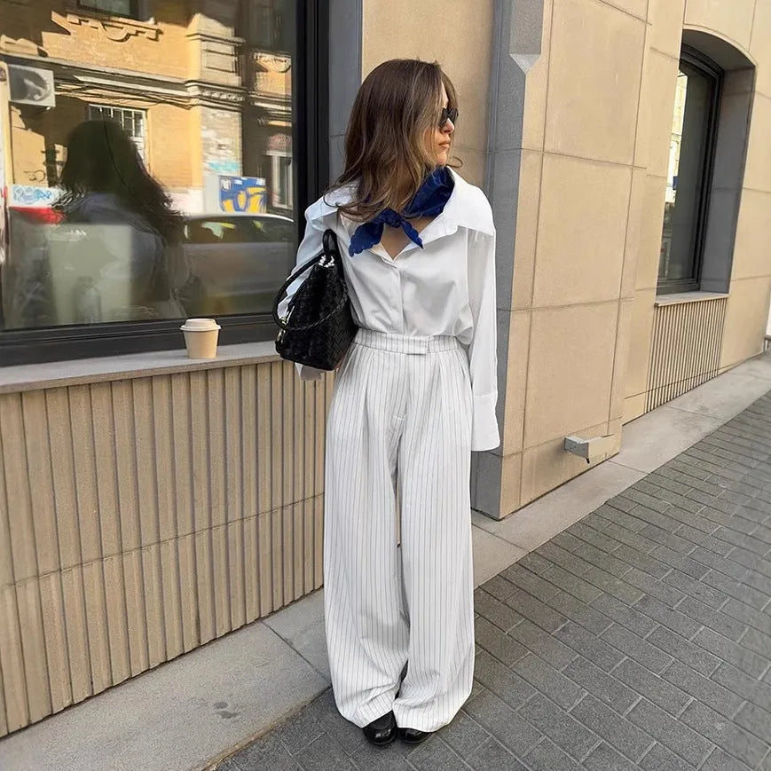 White striped wide-leg casual trousers with a zip closure on a hanger.